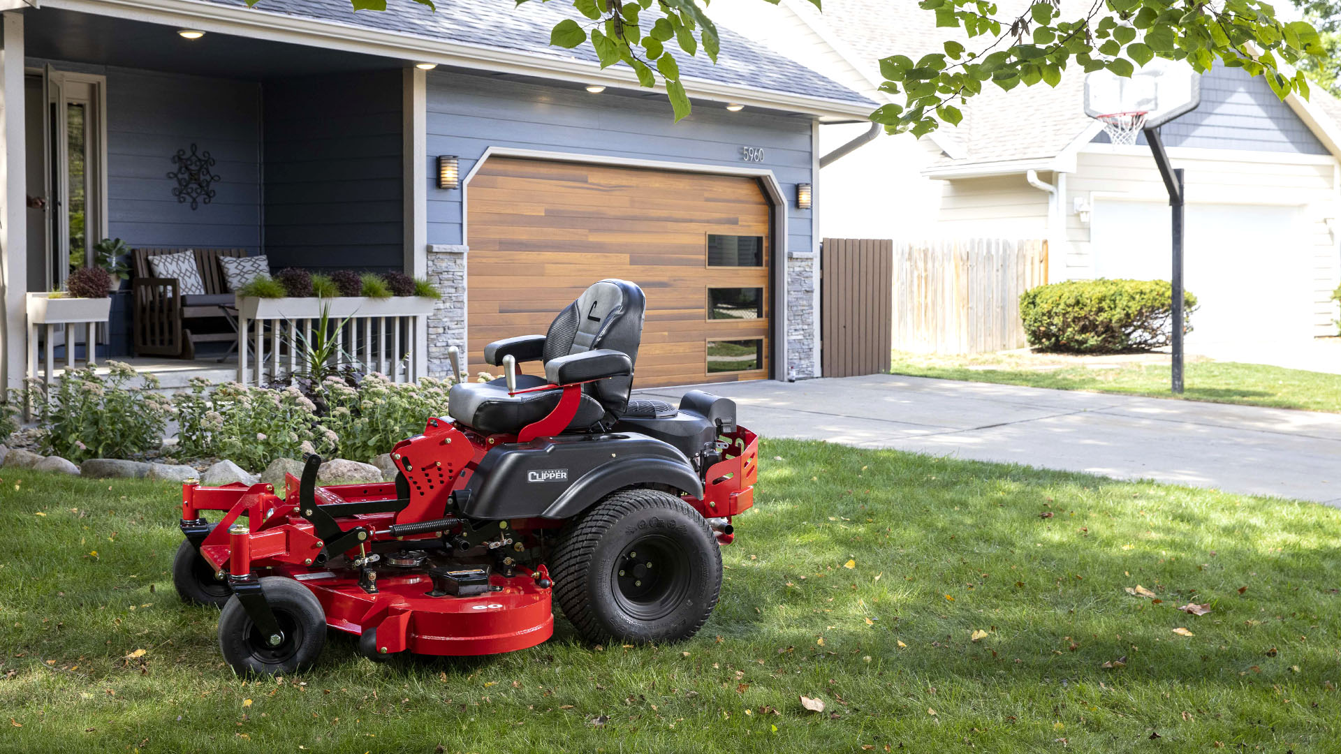 Country Clipper residential grade zero-turn mower with joystick steering in the front yard.
