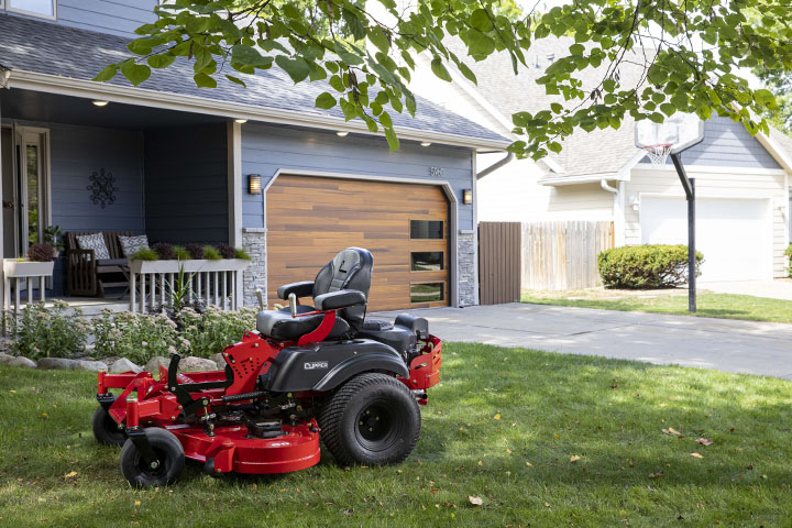 Country Clipper residential grade zero-turn mower with joystick steering in the front yard.